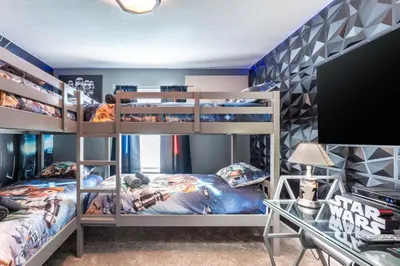 a bedroom with two bunk beds and a desk at Family Retreat near Disney with Pool & Hot Tub! in Kissimmee