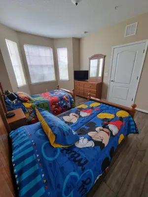 a bedroom with two beds with cartoon characters on it at Comfortable Apartment, Close to Disney World in Kissimmee