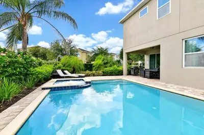 a swimming pool in front of a house at Lively Home Near Disney With Private Pool, Game And Themed Rooms With Waterpark & Resort Access At Encore Resorts Reunion - 670La in Kissimmee