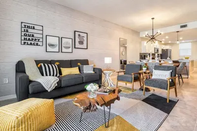 a living room with a couch and a table at Modern Luxe Condo - Stunning Design in Kissimmee