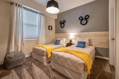 a bedroom with two beds and a window at Modern Luxe Condo - Stunning Design in Kissimmee