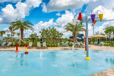 a pool with water fountains in a resort at Urban Elegance - Modern Retreat in Kissimmee