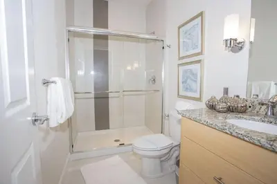 a bathroom with a shower and a toilet and a sink at Charming Cozy Haven in Orlando