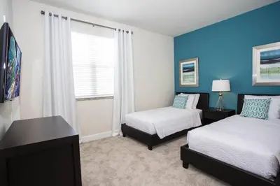 a hotel room with two beds and a window at Charming Cozy Haven in Orlando