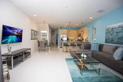a large living room with a couch and a table at Charming Cozy Haven in Orlando