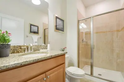 a bathroom with a shower and a toilet and a sink at Spacious Cozy Comfort in Every Corner in Kissimmee