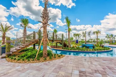 a pool at the resort with a slide and palm trees at Spacious Cozy Comfort in Every Corner in Kissimmee