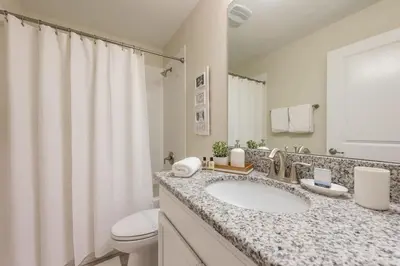 a white bathroom with a sink and a toilet at Chic Luxury Haven - Unforgettable Retreat in Kissimmee