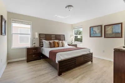 a bedroom with a large bed and a window at Enjoy the Large Pool - 6BR BL220 in Kissimmee