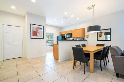 a kitchen and dining room with a table and chairs at Spectacular House with 3BR - Private Pool, BBQ - Minutes from Disney! in Kissimmee