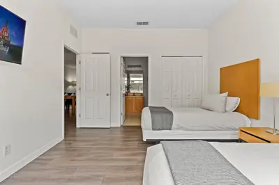 a bedroom with two beds and a hallway at 4 BR Hot Tub Cozy Decor @ Regal Oaks RO2761N in Kissimmee