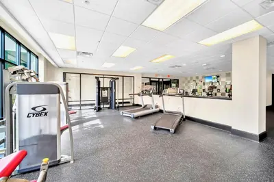 a gym with treadmills and machines in a building at Near Disney - 3BR Condo - Pool and Games in Orlando