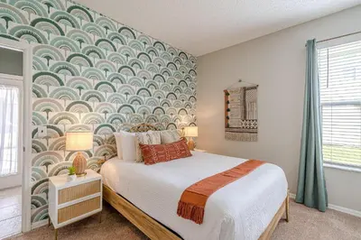 a bedroom with a bed with a wall mural at 8575 - 7th Heaven Villa in Kissimmee