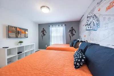 a bedroom with two beds and a map on the wall at Themed 4BR Home-Mickey & Star Wars Pool Spacious in Kissimmee