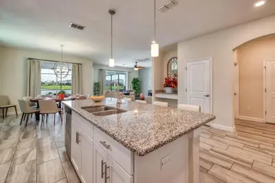 a kitchen and living room with a counter and a table at Stunning Home Private Pool Great Location in Kissimmee
