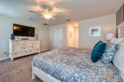 a bedroom with a bed and a ceiling fan at Stunning Home Private Pool Great Location in Kissimmee