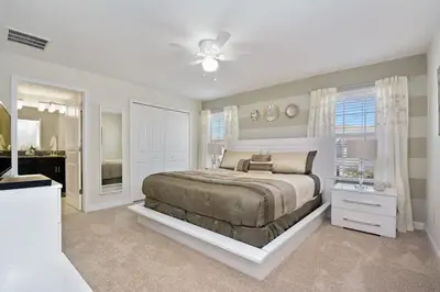 a bedroom with a bed and a ceiling fan at Storey Lake Townhome 3076 in Kissimmee