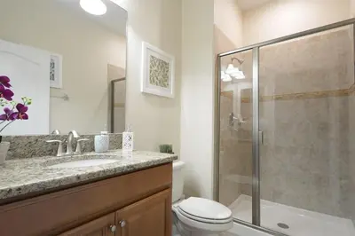 a bathroom with a shower and a toilet and a sink at Charming 4 BDR townhome at Storey Lake Resort in Kissimmee