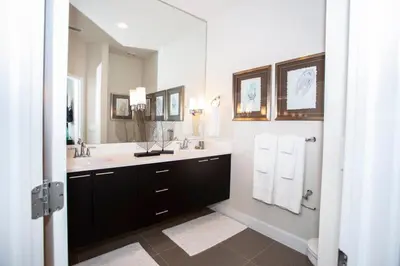 a bathroom with a sink and a large mirror at Serene Villa with Private Pool in Orlando