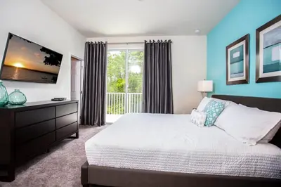 a bedroom with a bed and a large window at Serene Villa with Private Pool in Orlando