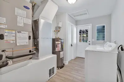 a white bathroom with a sink and a toilet at Modern Lake Front Casita near Winter Park! in Orlando