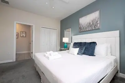 a bedroom with a large white bed in a room at Modern Marvel-Spacious, Themed, Fun-Filled in Kissimmee
