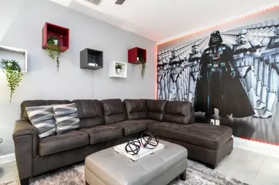 a living room with a brown leather couch at Modern Marvel-Spacious, Themed, Fun-Filled in Kissimmee