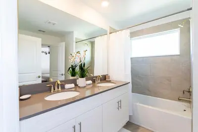 a bathroom with two sinks and a large mirror at Chic Modern Marvel, Themed Beds, Private Pool in Kissimmee