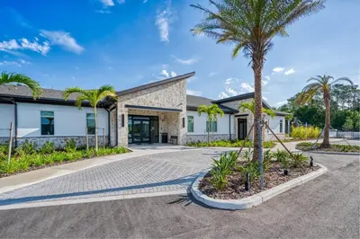 a house with a palm tree in front of it at Chic Modern Marvel, Themed Beds, Private Pool in Kissimmee