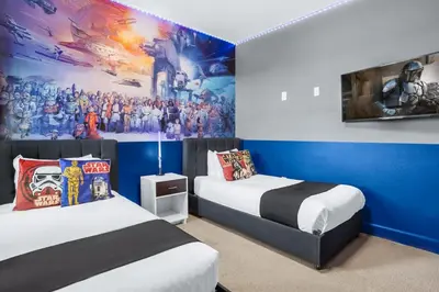 a room with two beds and a painting on the wall at Upstay Lakeside 10 Bedroom Home with Pool Private Cinema & Game Room in Kissimmee