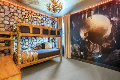 a bedroom with a large painting on the wall at Upstay Lakeside 10 Bedroom Home with Pool Private Cinema & Game Room in Kissimmee