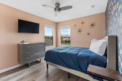 a bedroom with a bed and a window at 5BR Themed Pool Home Near Disney World in Kissimmee