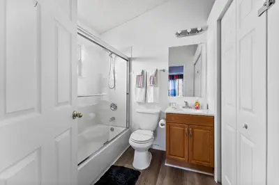 a bathroom with a toilet and a shower and a sink at 5BR Themed Pool Home Near Disney World in Kissimmee