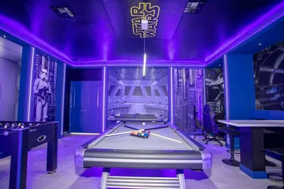 a pool table in a room with purple lighting at Storey Lake House 2713 in Kissimmee