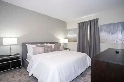 a bedroom with a large white bed and two lamps at Storey Lake House 2713 in Kissimmee