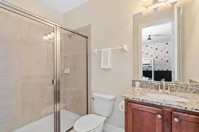 a bathroom with a toilet and a shower and a sink at 8 Bd home with Themed rooms and Pool 2308 in Orlando