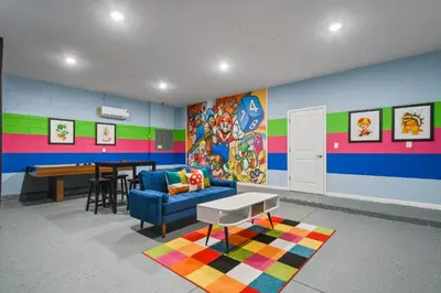 a colorful room with a couch and a table at Spacious Family Reunion 15BR Home Pool Spa Game Rm in Kissimmee
