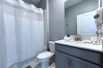 a bathroom with a toilet and a sink and a shower at Disney World-House Up to 18 ppl at Storey Lake-Cloud9 in Kissimmee