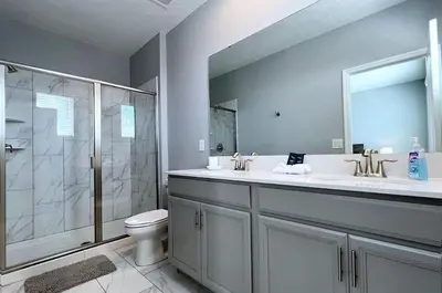 a bathroom with a shower and a sink and a toilet at Disney World-House Up to 18 ppl at Storey Lake-Cloud9 in Kissimmee