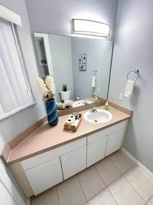 a bathroom with a sink and a mirror at Roomy House Near Disney with Resort Pool and Patio BBQ in Kissimmee