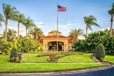 a house with an american flag in a park at Roomy House Near Disney with Resort Pool and Patio BBQ in Kissimmee