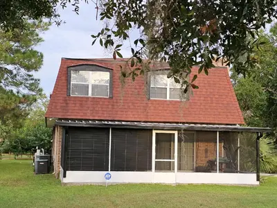 a house with a red roof and a garage at The Farm House in Sanford