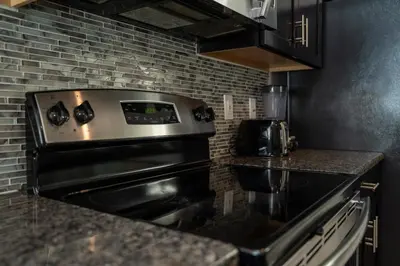 a kitchen with a stove and a counter top at Home with a pool at Storey Lake Resort in Kissimmee