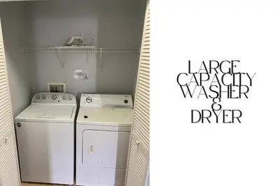 a small laundry room with a washer and dryer at Stunning 3BD Condo 14 Mins to Disney World , Gated in Kissimmee