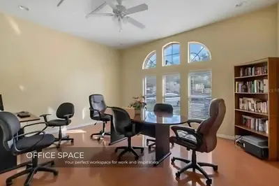 an office space with a table and chairs at Stunning 3BD Condo 14 Mins to Disney World , Gated in Kissimmee