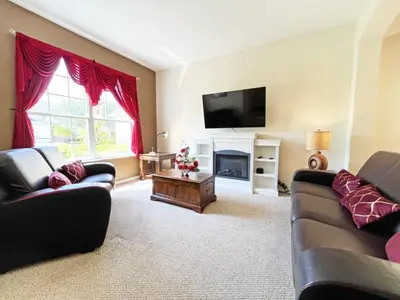 a living room with two couches and a television at Golden Beach Villa home in Kissimmee
