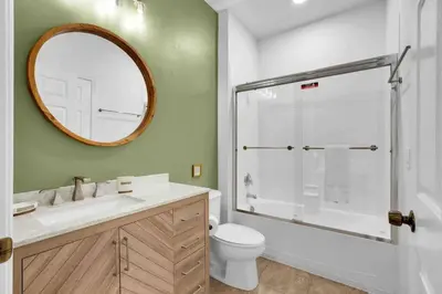 a bathroom with a shower and a toilet and a mirror at Remarkable Cozy 4Bed-3Ba Townhouse in Kissimmee