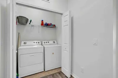 a white laundry room with a washer and dryer at Remarkable Cozy 4Bed-3Ba Townhouse in Kissimmee