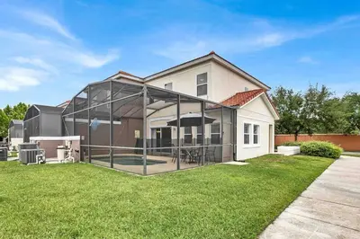 a house with a lot of glass in the yard at Remarkable Cozy 4Bed-3Ba Townhouse in Kissimmee