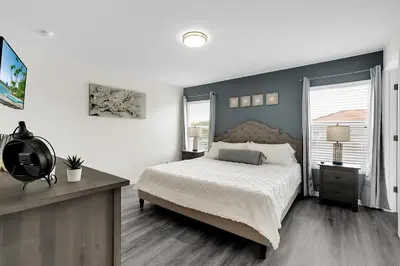 a bedroom with a large bed and a large window at Remarkable Cozy 4Bed-3Ba Townhouse in Kissimmee